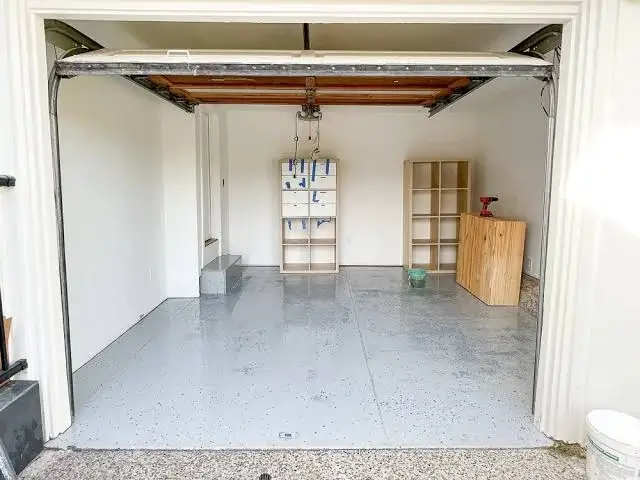 Old garage door removed, empty opening ready for insulated door installation