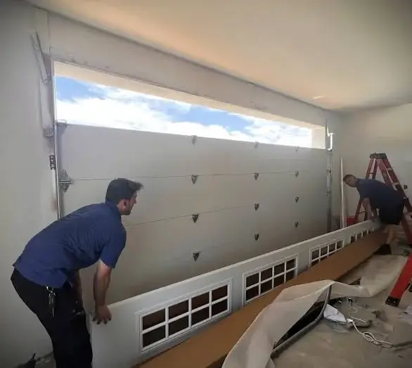Insulated garage door panel section lifted into place