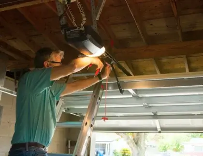 Technician installing a new garage door opener in Denver, CO