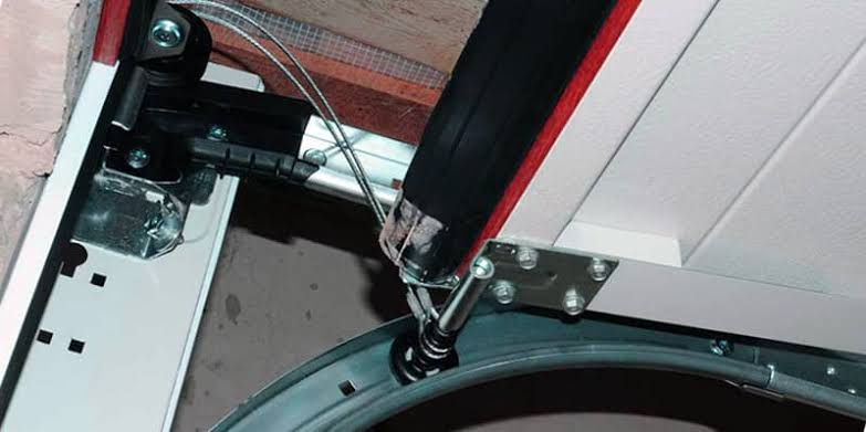 Installing frame, track, and rollers for insulated garage door