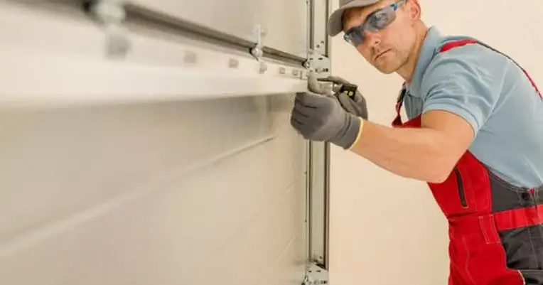 Technician measuring for insulated garage door panel fit